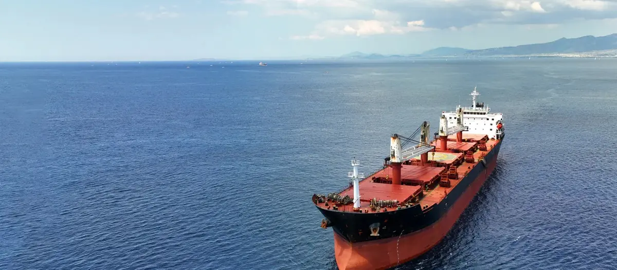 Bulk carrier at sea under a clear sky
