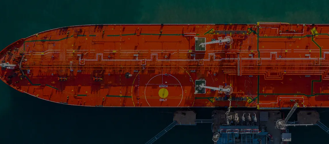 Tanker deck seen from above, alongside a terminal